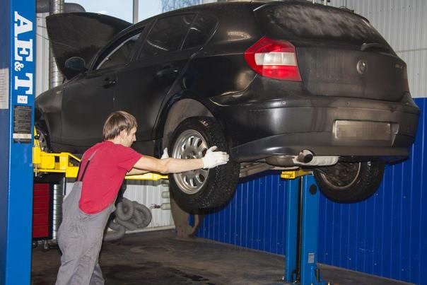 специалист осматривает авто перед заменой масла